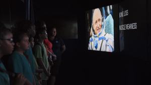 Participants watch a video in a mobile exhibit 